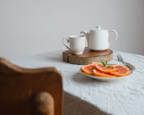 A calm breakfast table setup in a Chilean home with natural light